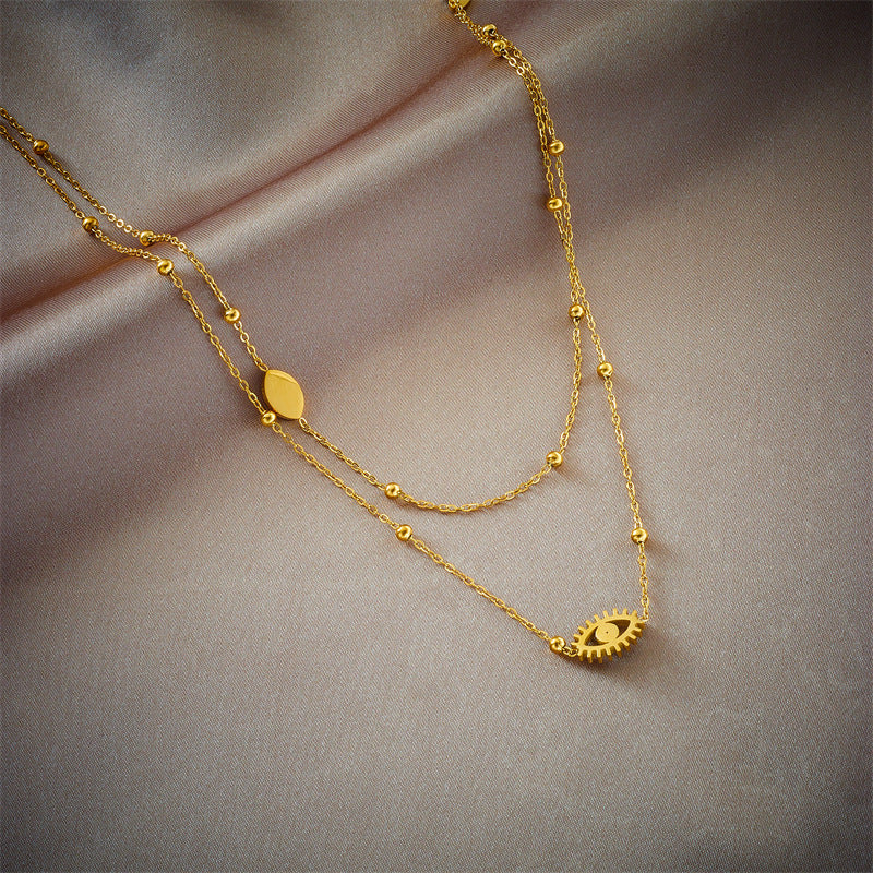 European and American niche fashion design double-layer mixed chain gold bead titanium steel drip oil hollow blue eye pendant necklace