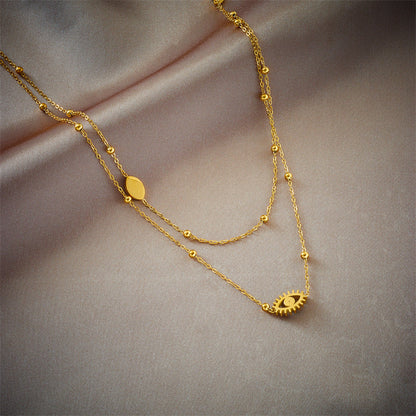 European and American niche fashion design double-layer mixed chain gold bead titanium steel drip oil hollow blue eye pendant necklace